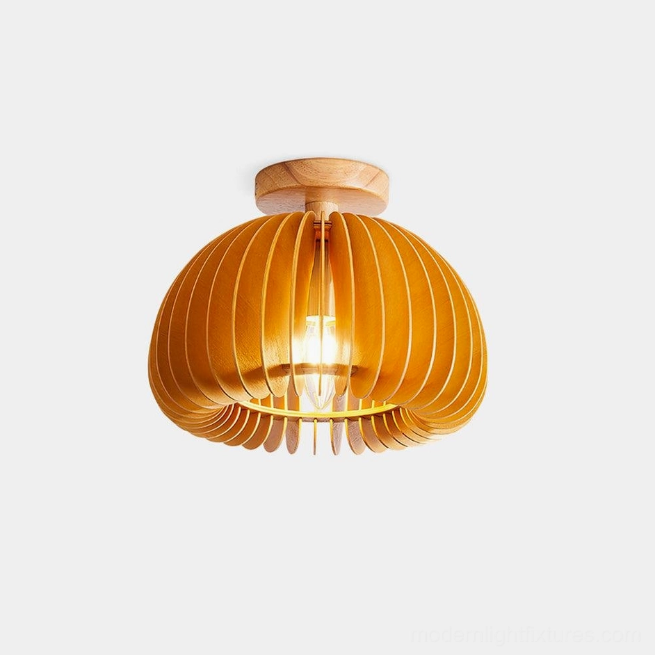 Layered wood pumpkin ceiling light fixture with warm illumination and organic basswood slats