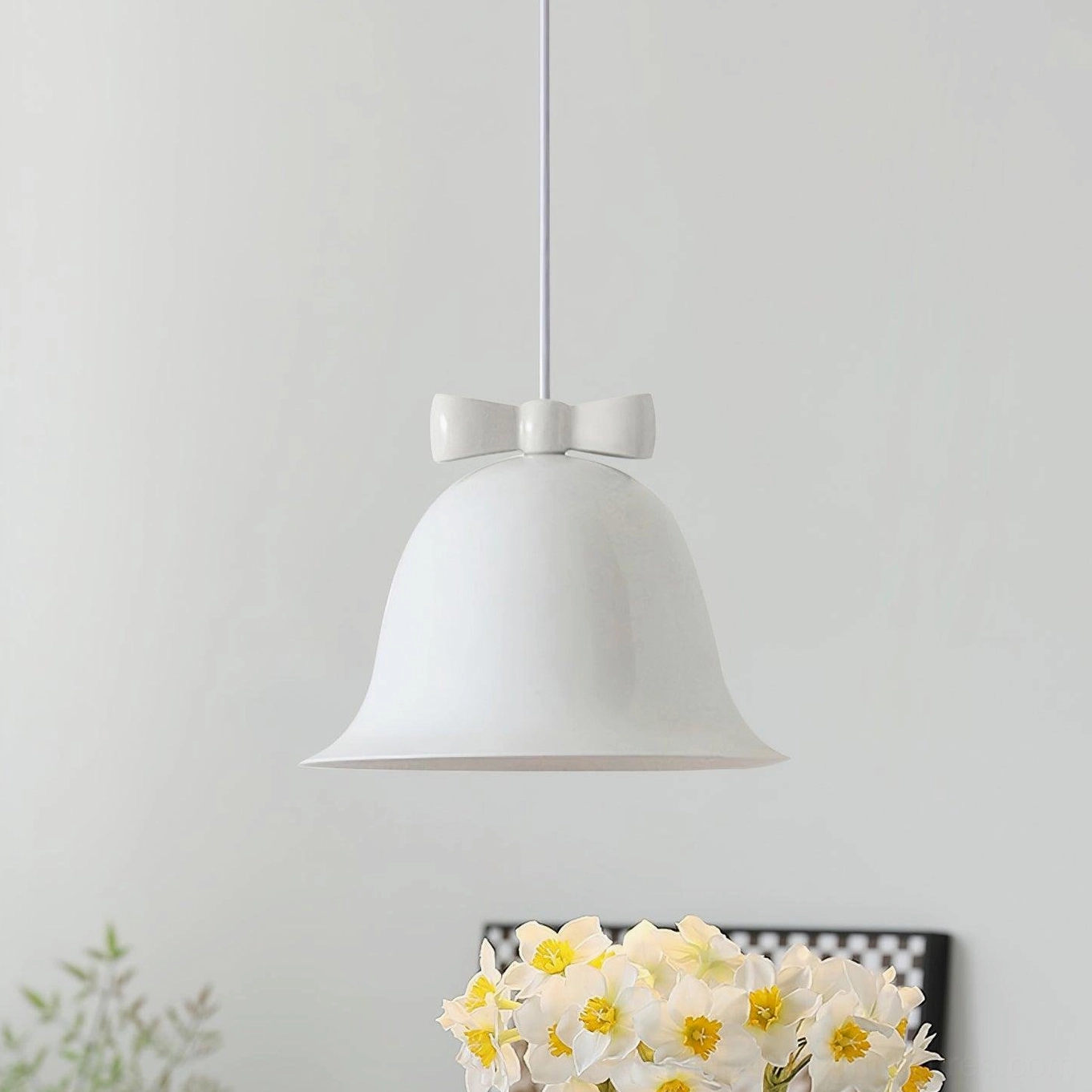 Pure white glossy ceramic bell-shaped pendant light with brown bow detail studio photography
