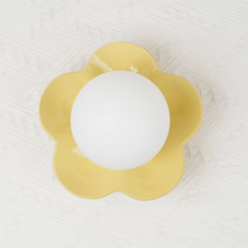 Purple Fleur wall sconce beside bedside table - intimate warm lighting modern wall lamp for bedroom sanctuary