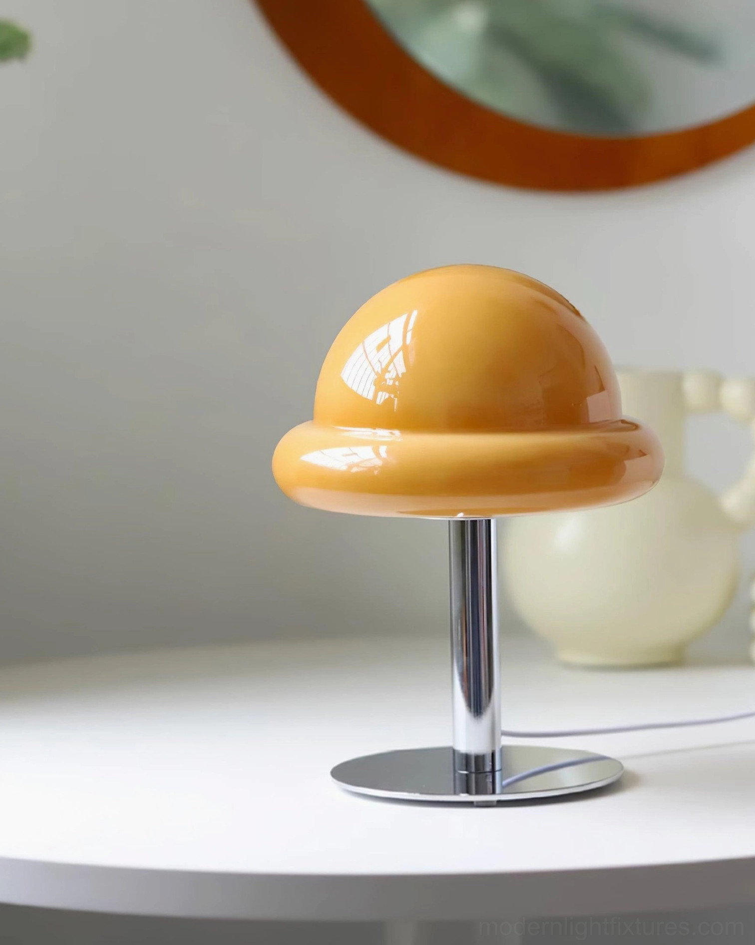 Purple glossy mushroom glass table lamp creating ambient lighting in contemporary living space