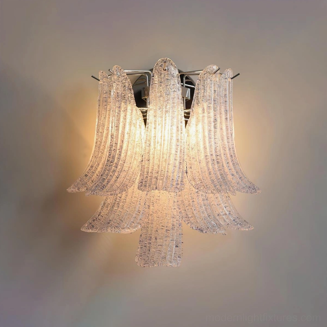Purple petal glass wall sconce glowing against neutral background, displaying soft radiant light waves from textured petals