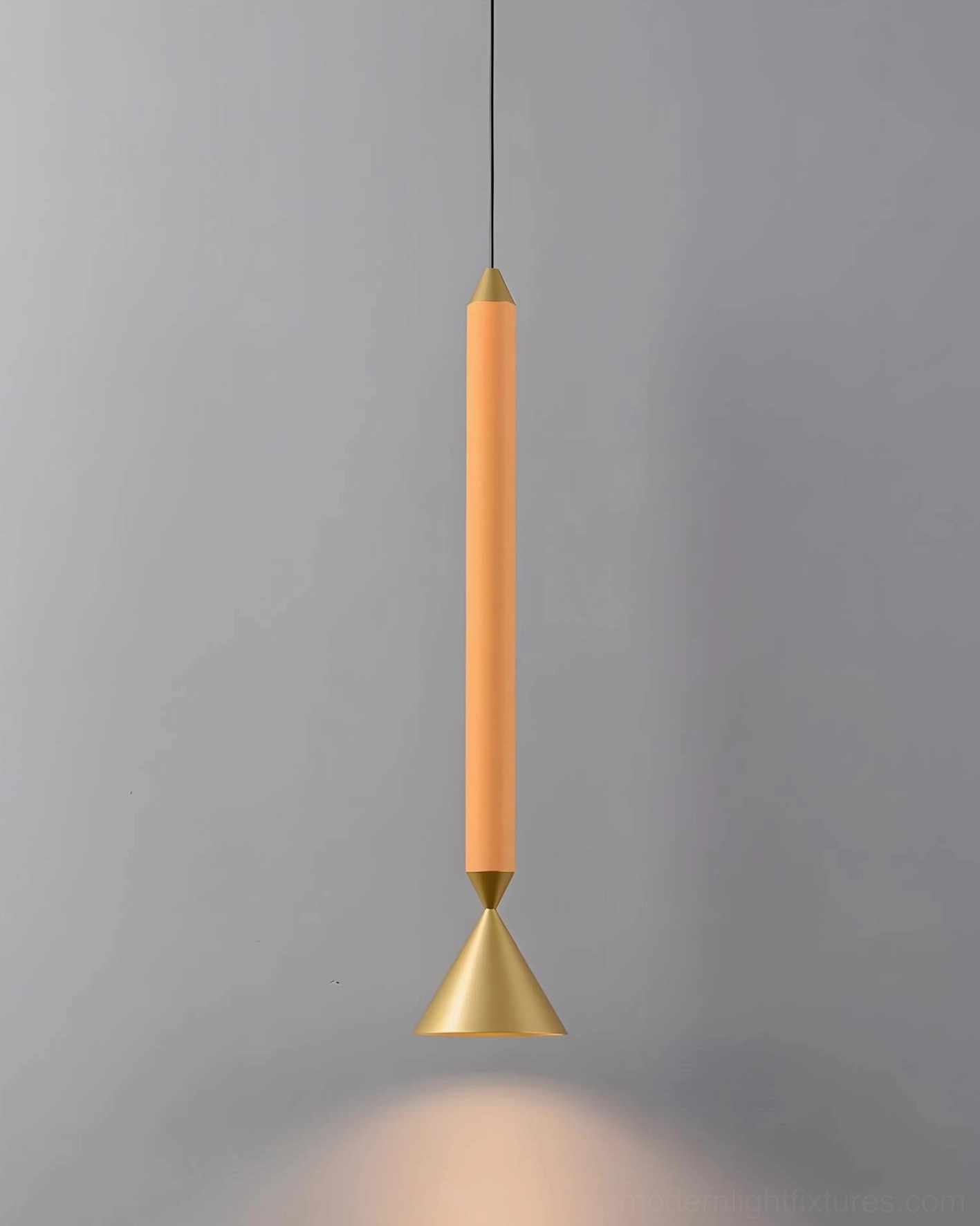 Orange Pylon pendant light with gold conical diffuser, matte finish on gray background showing warm light distribution