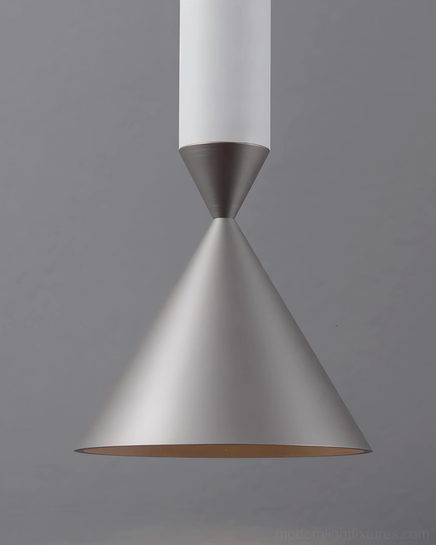 Pink Pylon pendant light fixture showing color intensity and warm light output from integrated LED