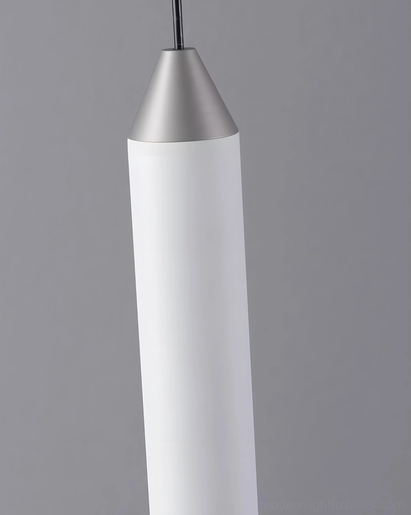 Red accent Pylon pendant light with chrome base, cylindrical modern design suspended above surface