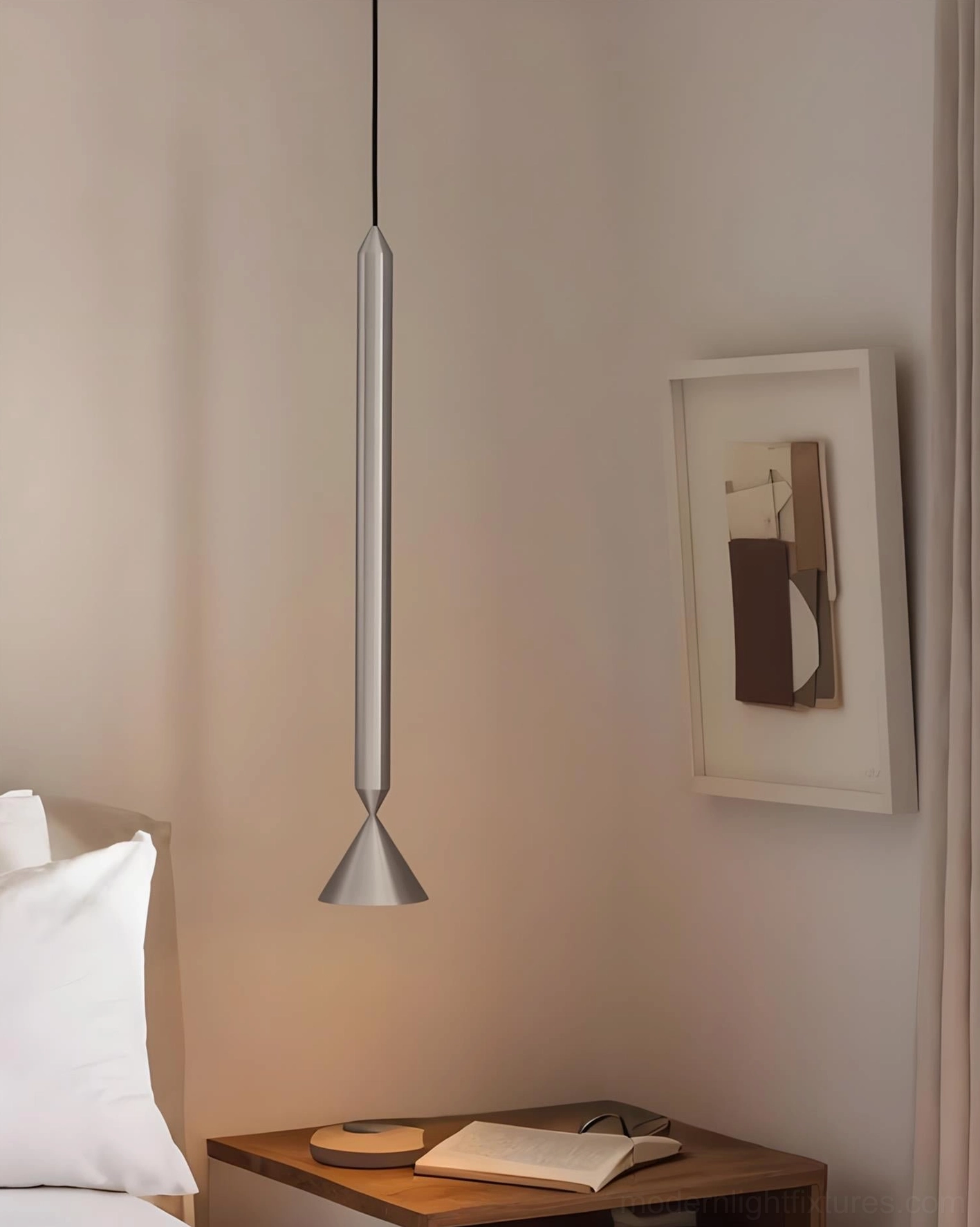 Silver Pylon pendant light installed in minimalist bedroom above bedside table, showing matte metallic finish and cone diffuser