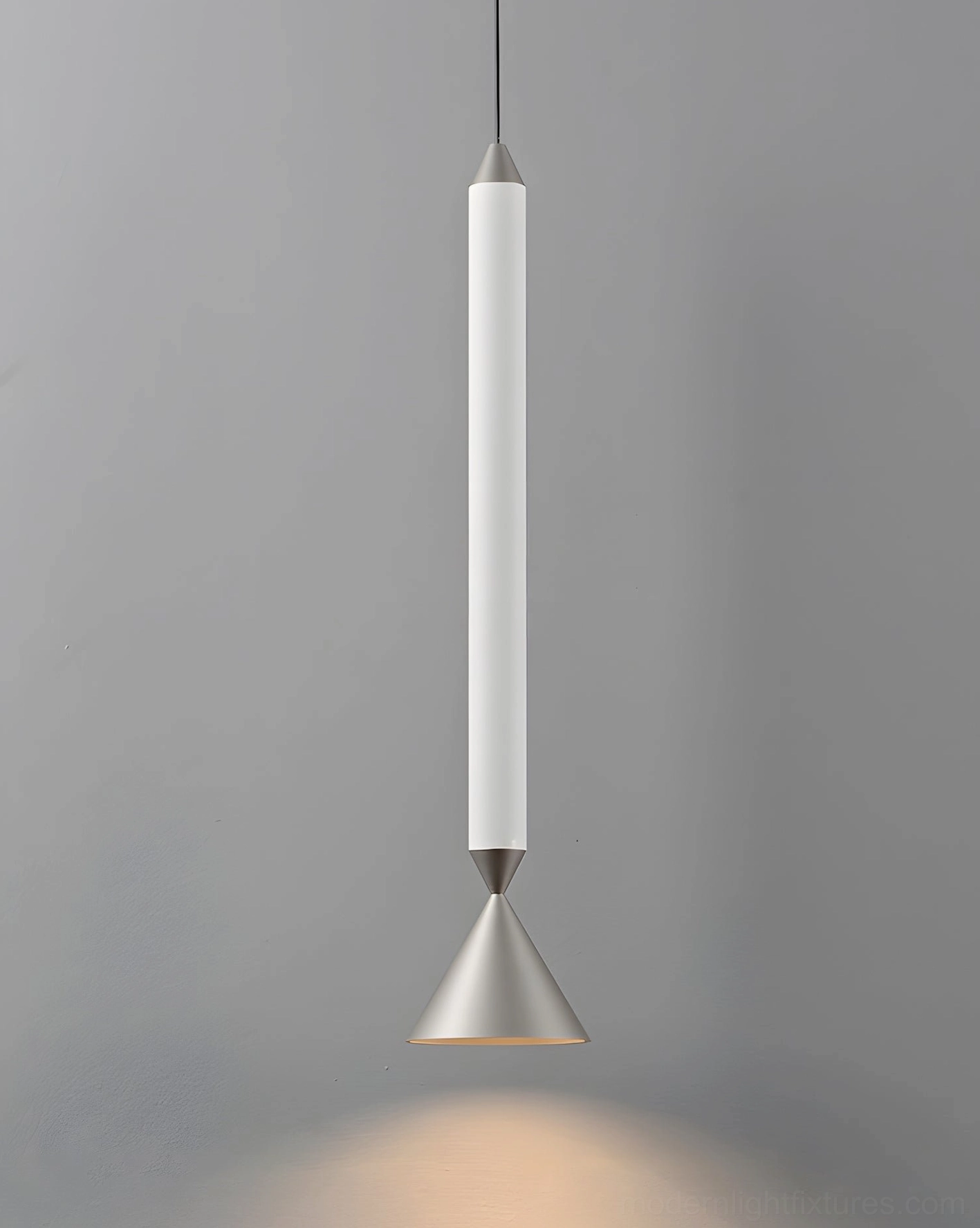 White matte Pylon pendant light with silver metal cone base, minimalist cylindrical design on gray background