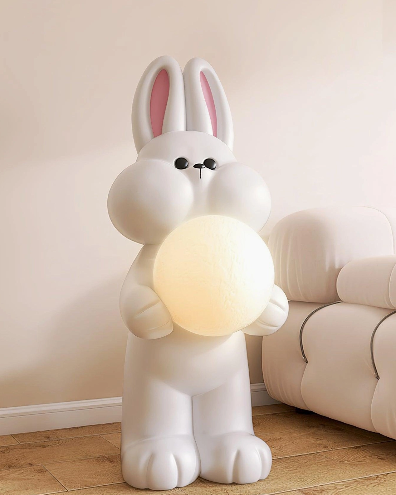 Illuminated rabbit floor lamp with warm yellow moon light and pink inner ears in cozy living room