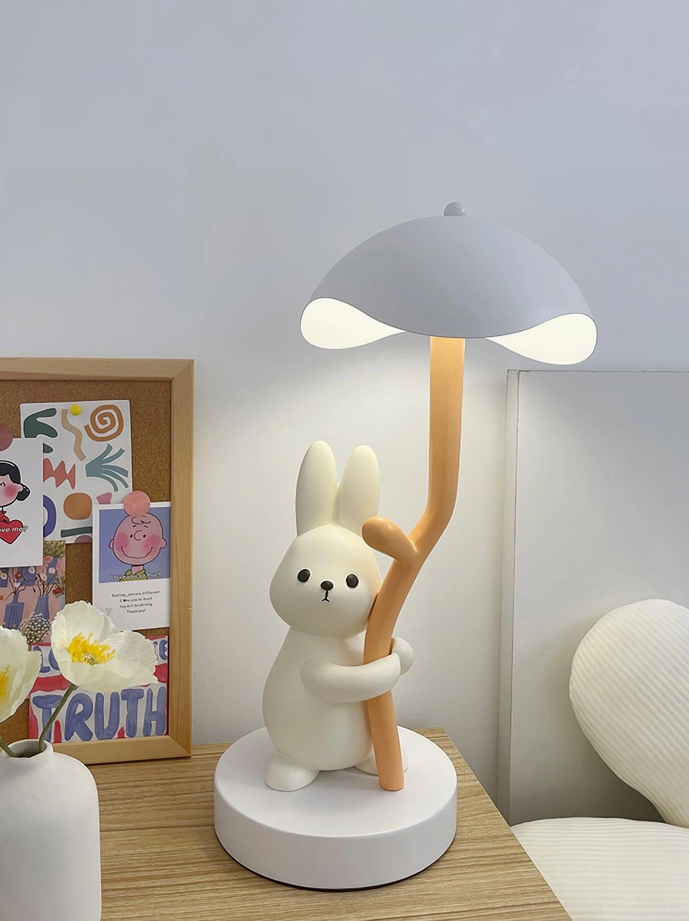 Rabbit hug table lamp with gray shade in bedroom bedside table with cozy setup