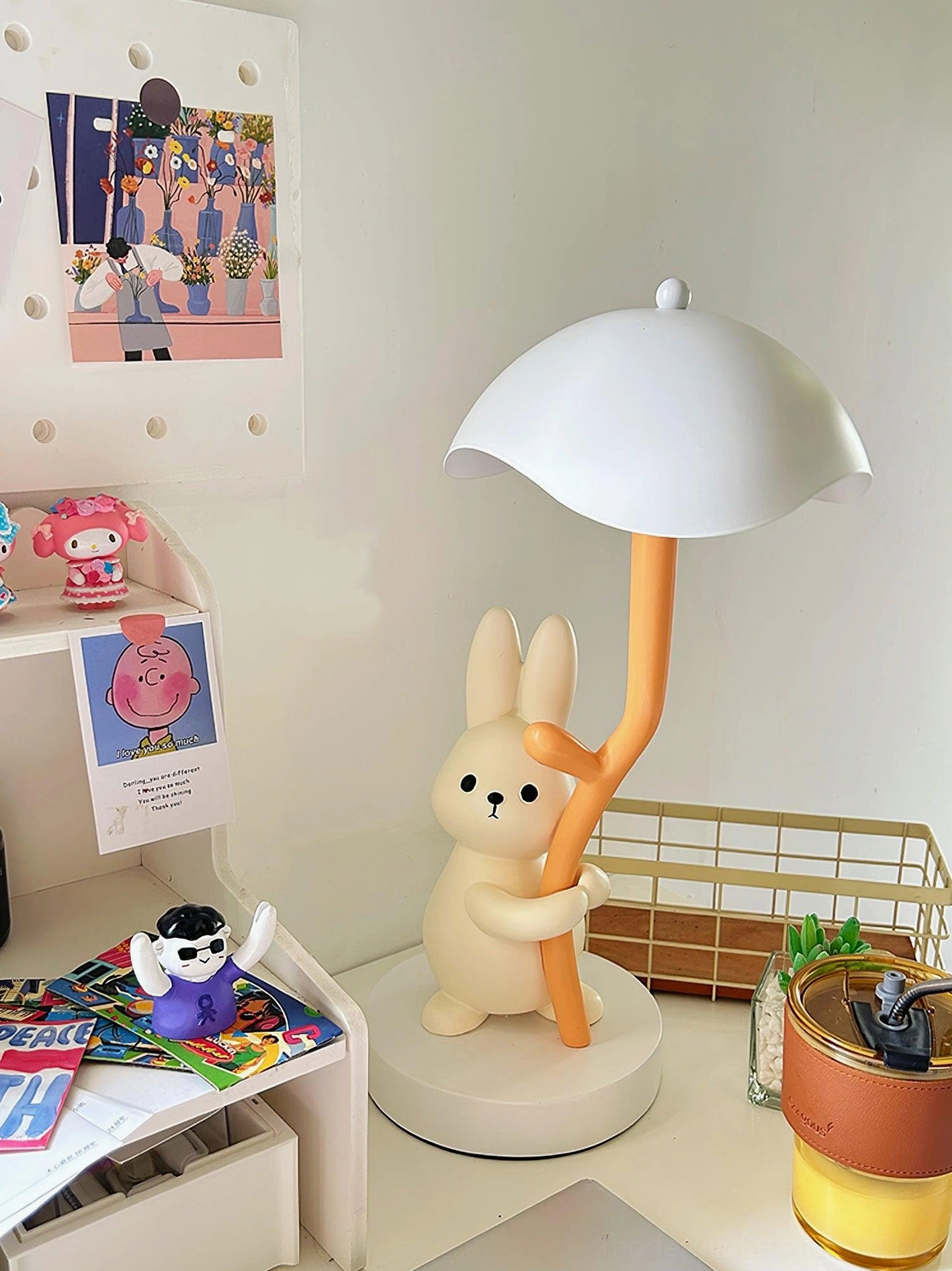 Rabbit hug table lamp three-quarter view on home desk workspace with decorations