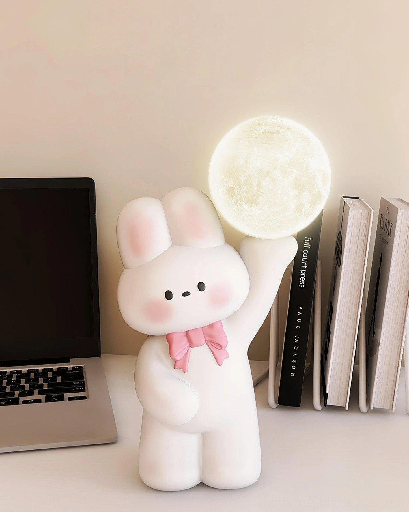 Illuminated white rabbit table lamp with glowing moon bulb on home office desk - integrated LED desk lamp