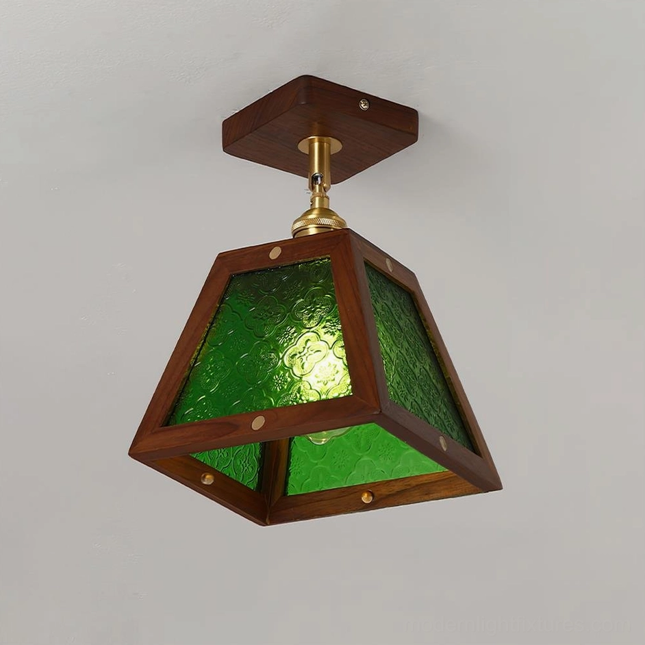 Radia trapezoid pendant lamp front three-quarter view with green patterned stained glass and dark wood frame