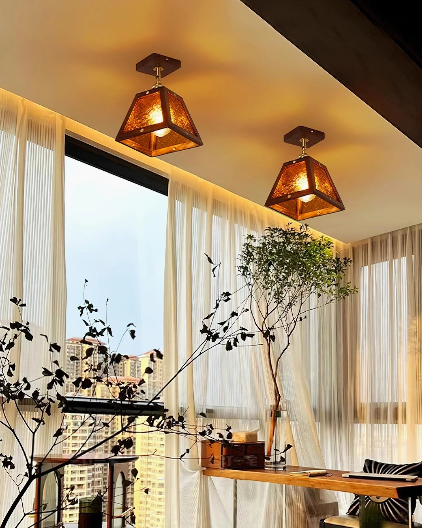 Pair of Radia trapezoid stained glass ceiling lights in residential balcony workspace with warm vintage ambient glow