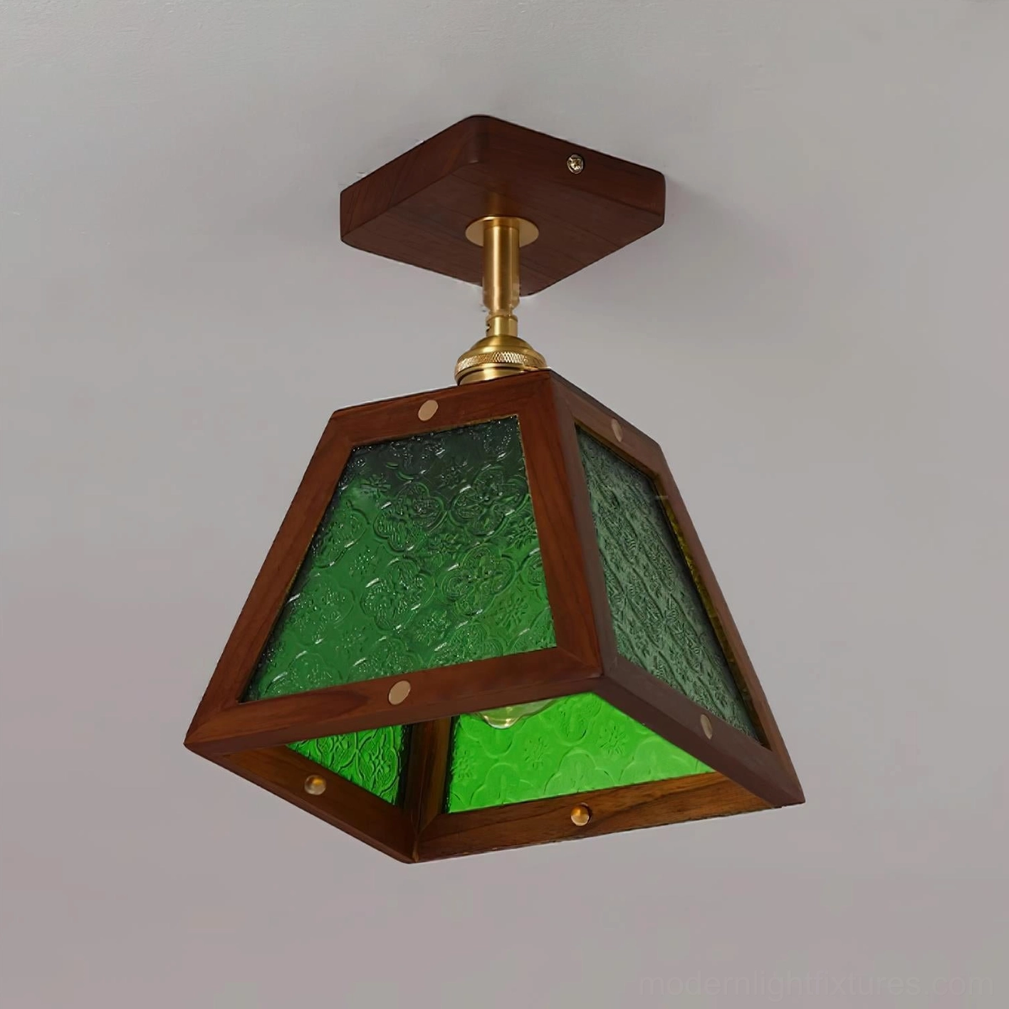 Radia ceiling pendant with two-tone green patterned stained glass, dark wood frame and brass fixtures