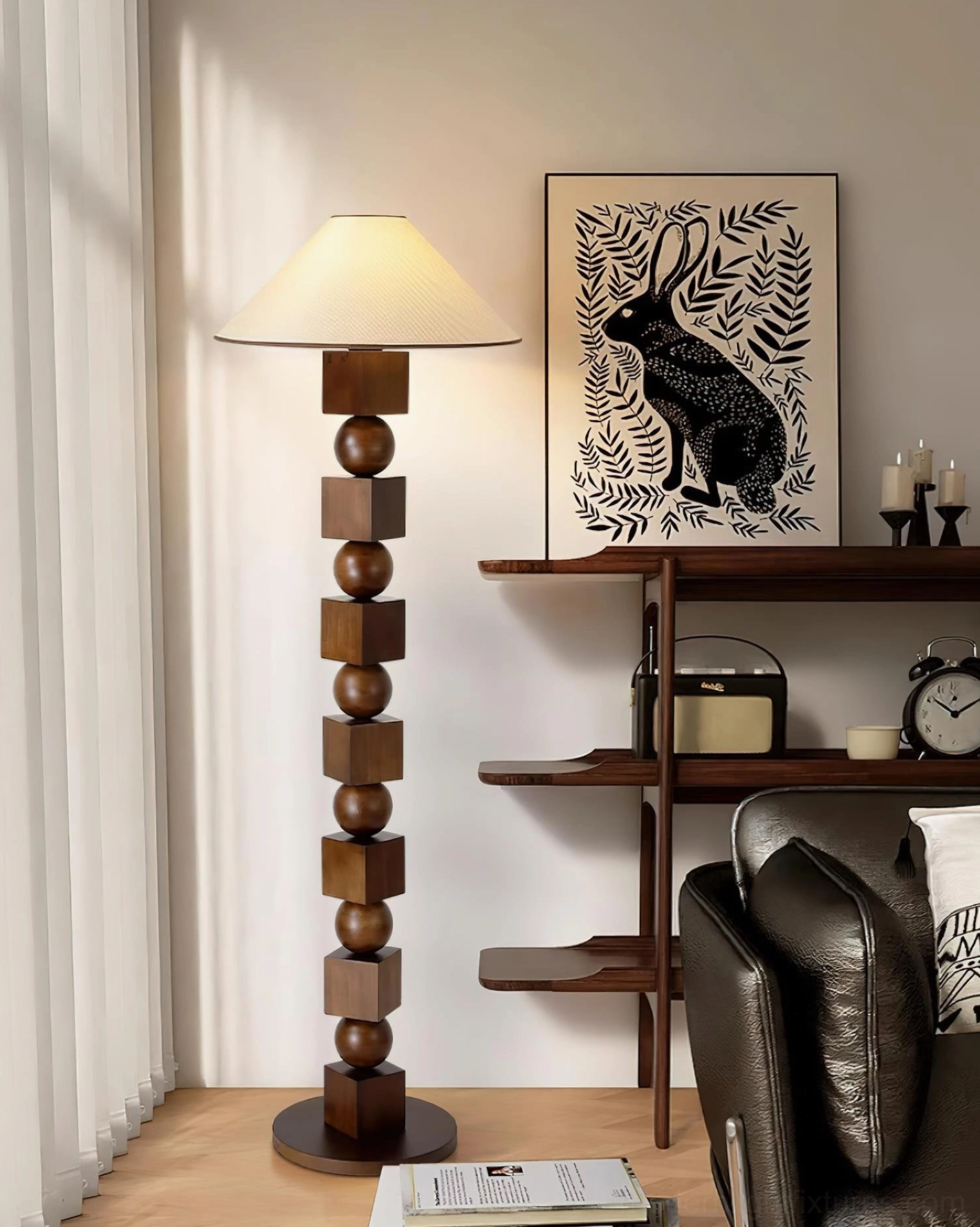 Dark wood retro-modern sculptural floor lamp in contemporary living room with leather sofa, wall shelf and artistic rabbit artwork backdrop