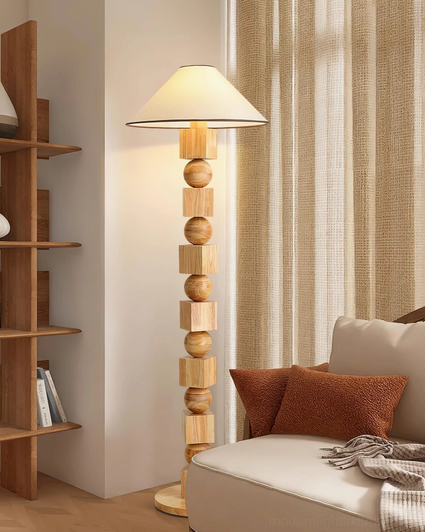 Natural light wood Radian floor lamp with minimalist bohemian design in cozy living room setting with bookshelf, side-front angle showing glowing warm shade