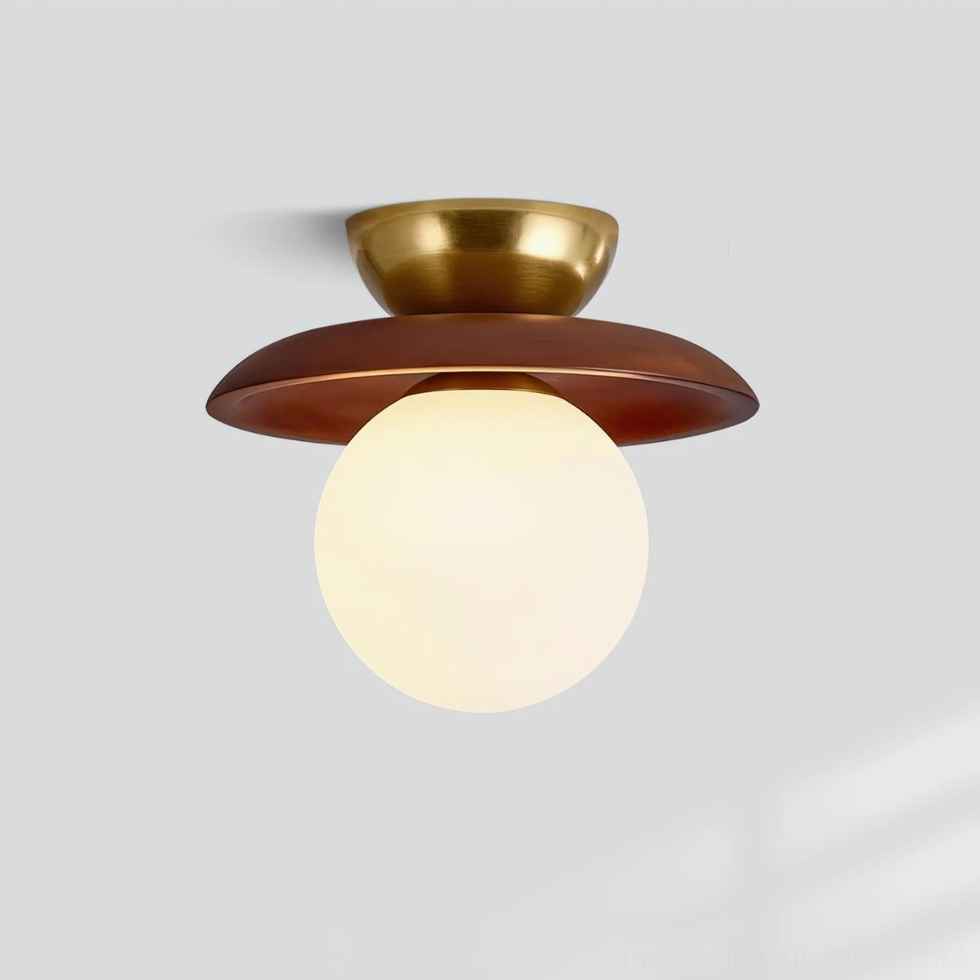 Lit Radiora mid-century modern ceiling fixture with soft warm light diffusion through opal glass