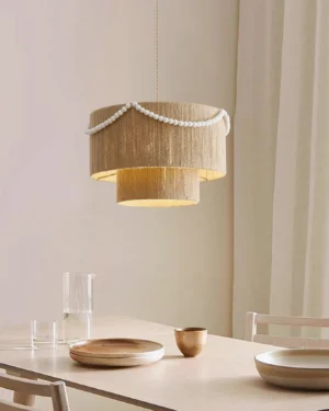 Raffine hemp rope pendant light suspended above wooden dining table in warm residential dining room setting