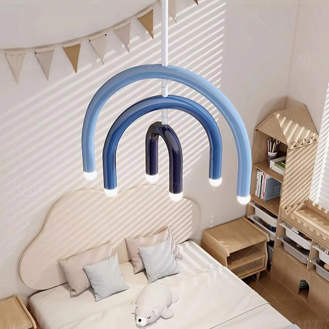 Blue gradient rainbow arc pendant in cozy children's bedroom with warm home decor