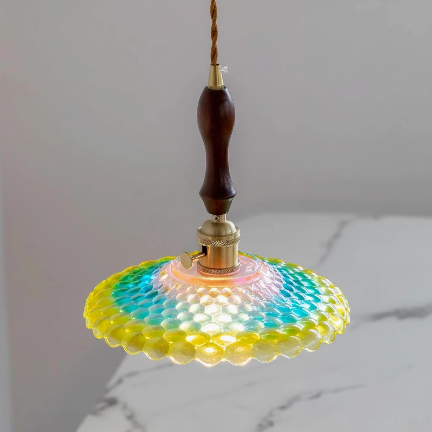 Close-up overhead view of Rainbowa pendant shade on marble surface showing honeycomb glass texture detail
