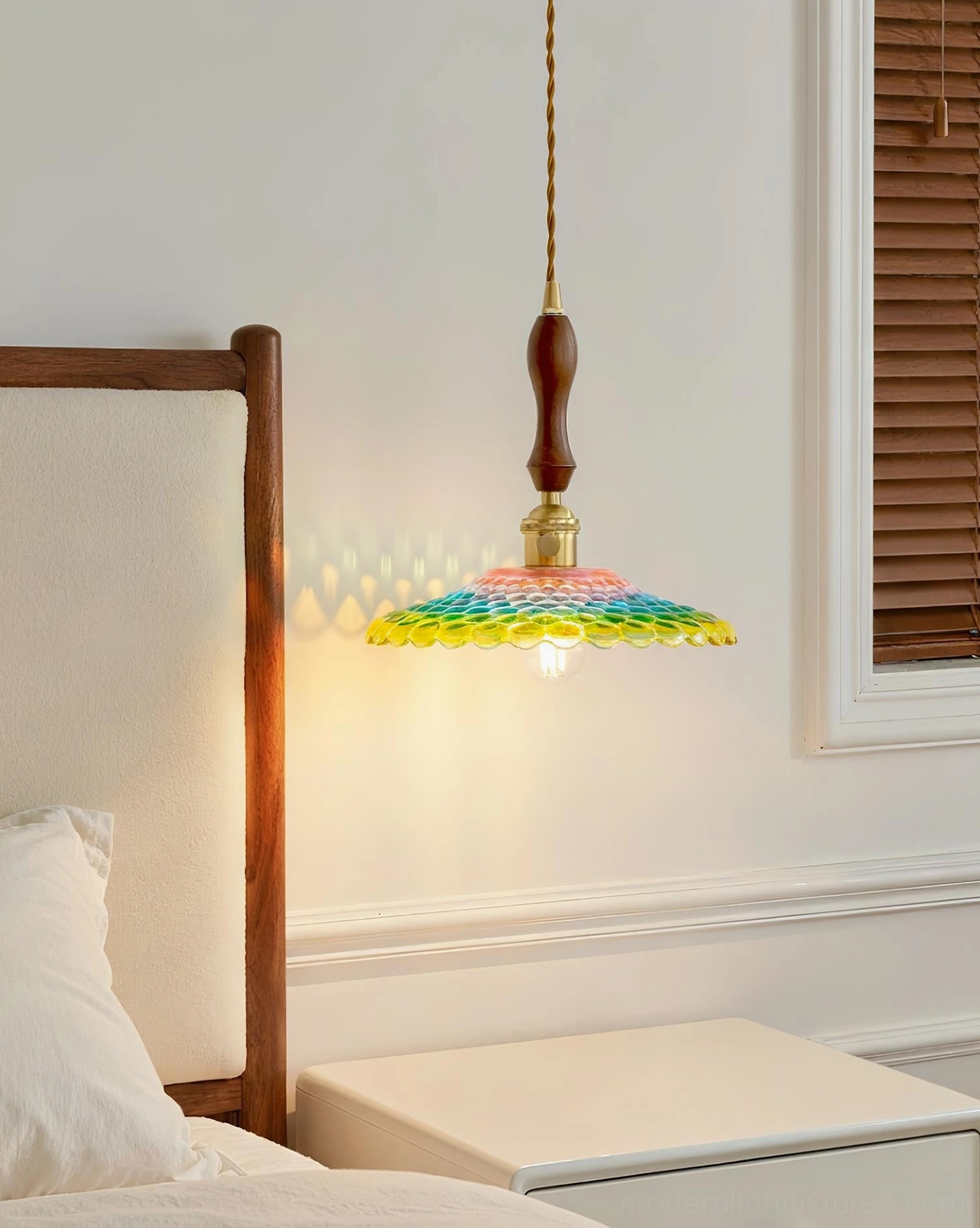 Rainbowa glass pendant mounted beside master bedroom window with nightstand styling