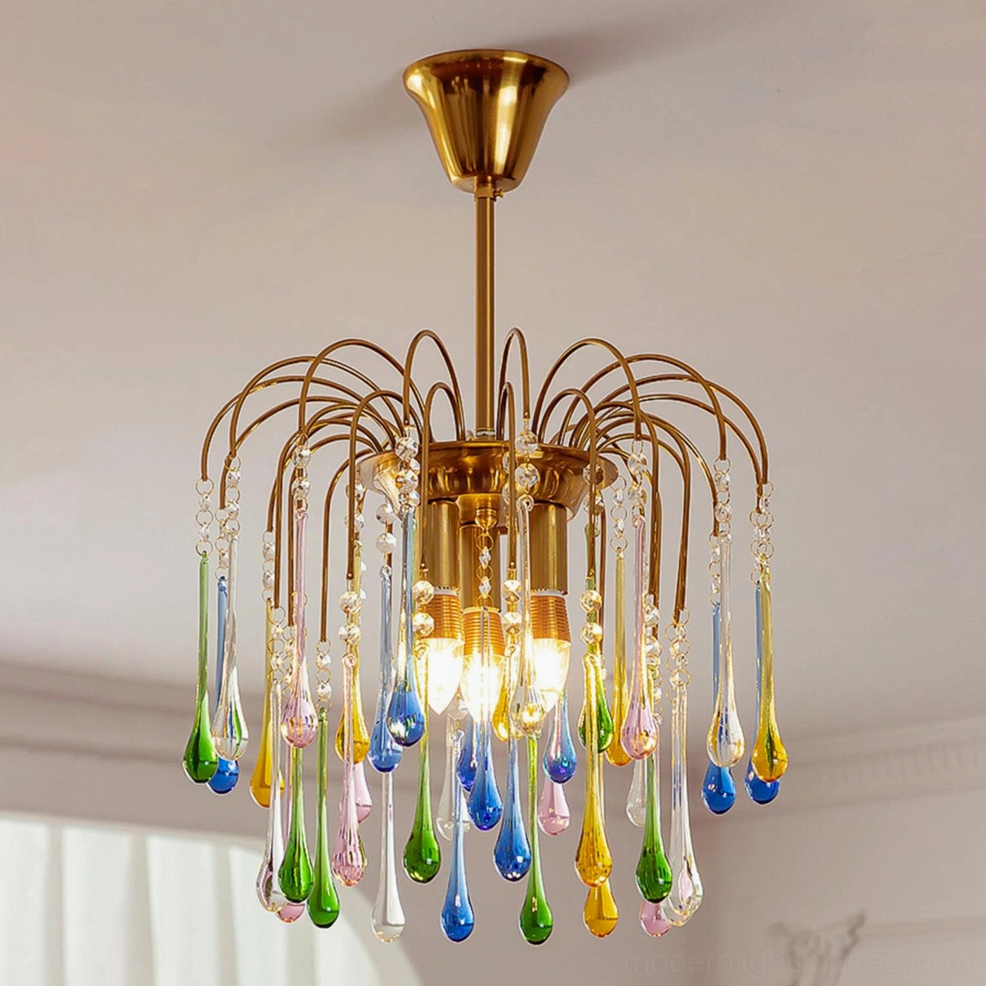 Rainlight chandelier three-quarter perspective showing interior E14 bulbs and suspended glass teardrop design