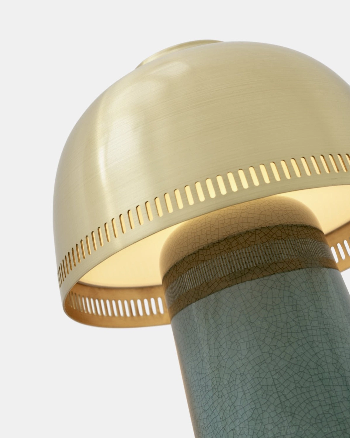 Raku ceramic table lamp close-up lit interior glow crackled teal ceramic base artisan handcrafted