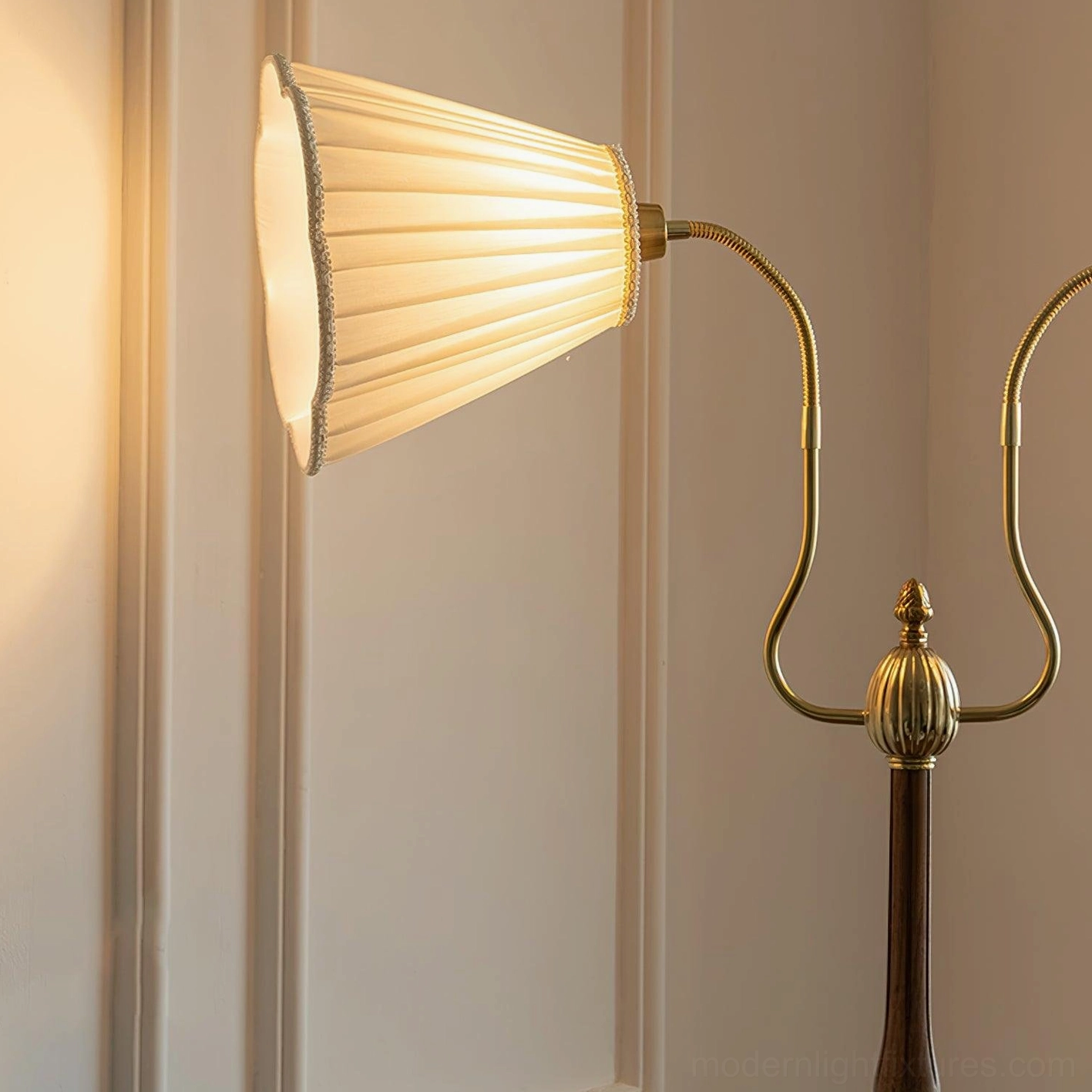 Ramira single-arm curved floor lamp detail showing ornate brass joint and adjustable positioning capability