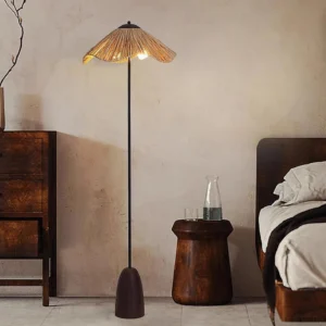 Rania woven floor lamp in wabi-sabi bedroom setting, warm ambient lighting beside vintage wooden furniture