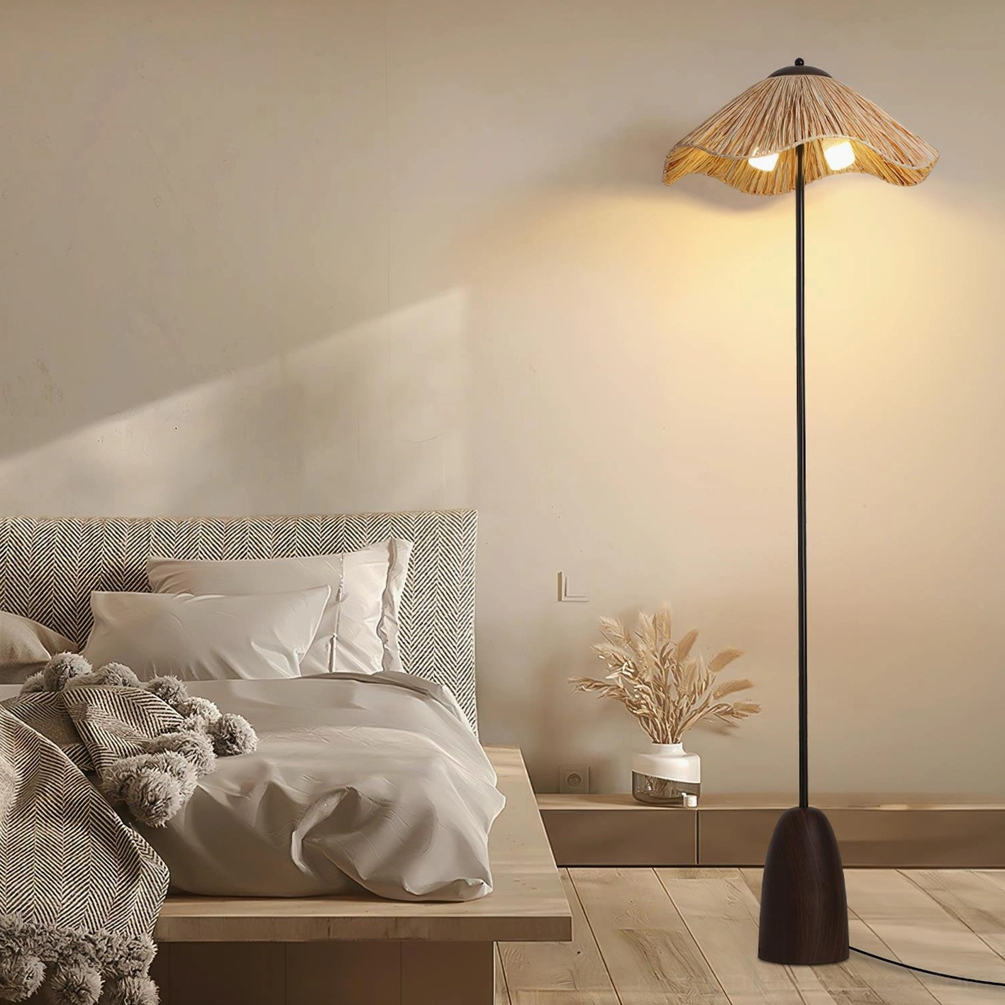Rania woven floor lamp beside master bedroom bedside with potted plant decor and warm lighting