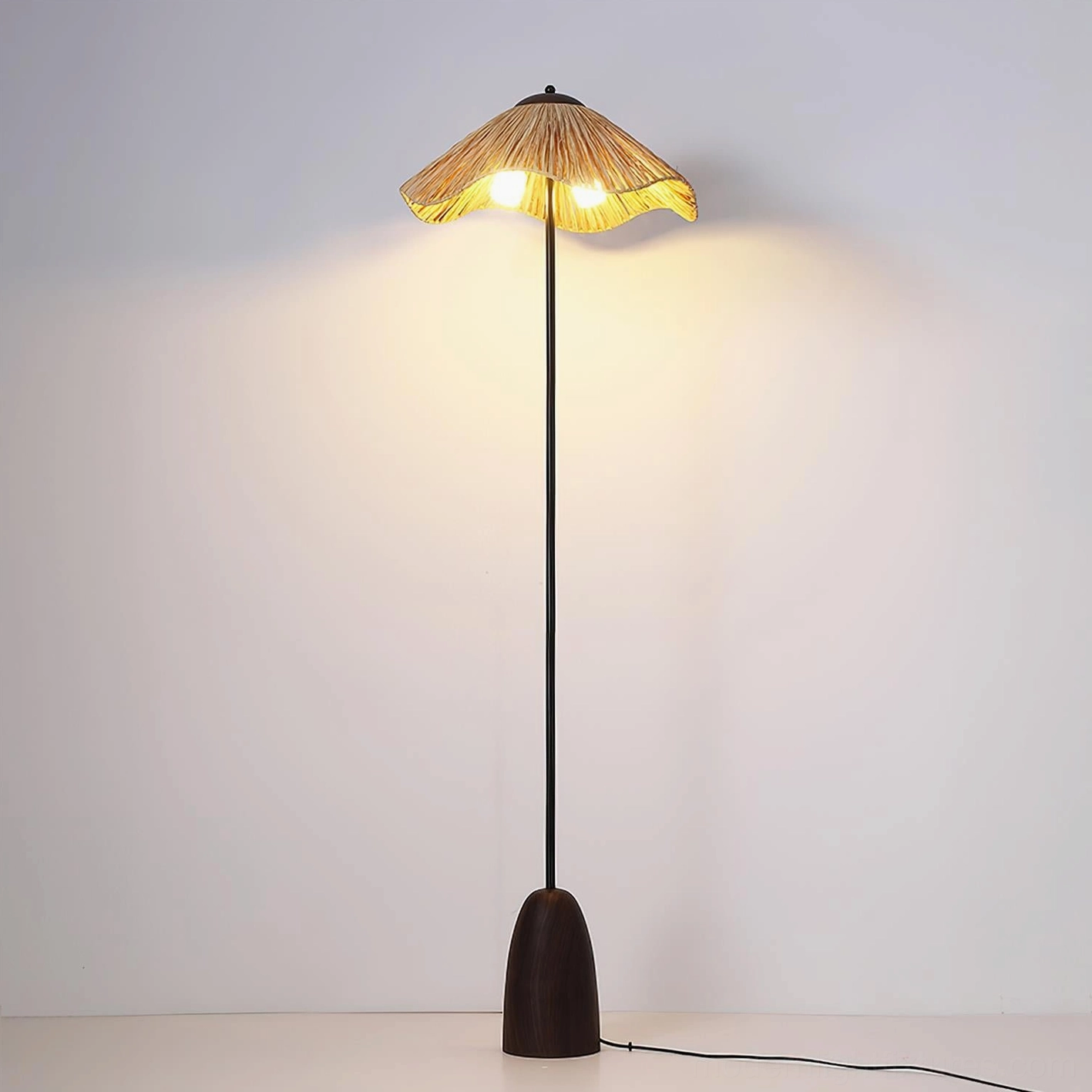 Rania woven shade floor lamp illuminated detail showing light transmission through raffia material