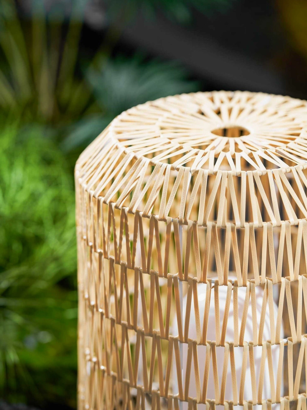 Woven rattan outdoor lamp soft light diffusion through natural fiber creating calm atmosphere