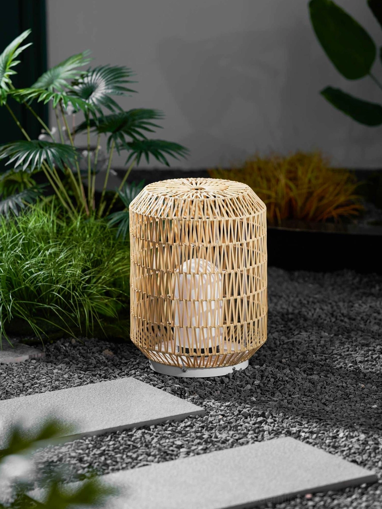 Rattan outdoor lamp materials detail showing metal frame rattan weave and acrylic diffuser