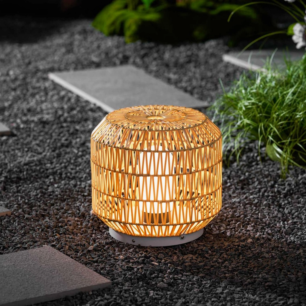 Rattan outdoor table lamp paired with mid-century modern outdoor seating arrangement