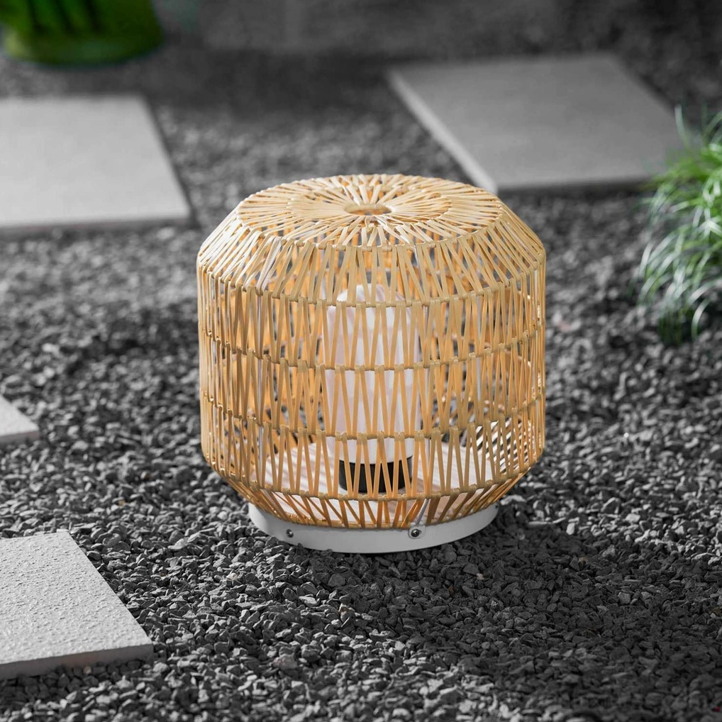Rattan outdoor table lamp paired with natural wood and steel contemporary furniture