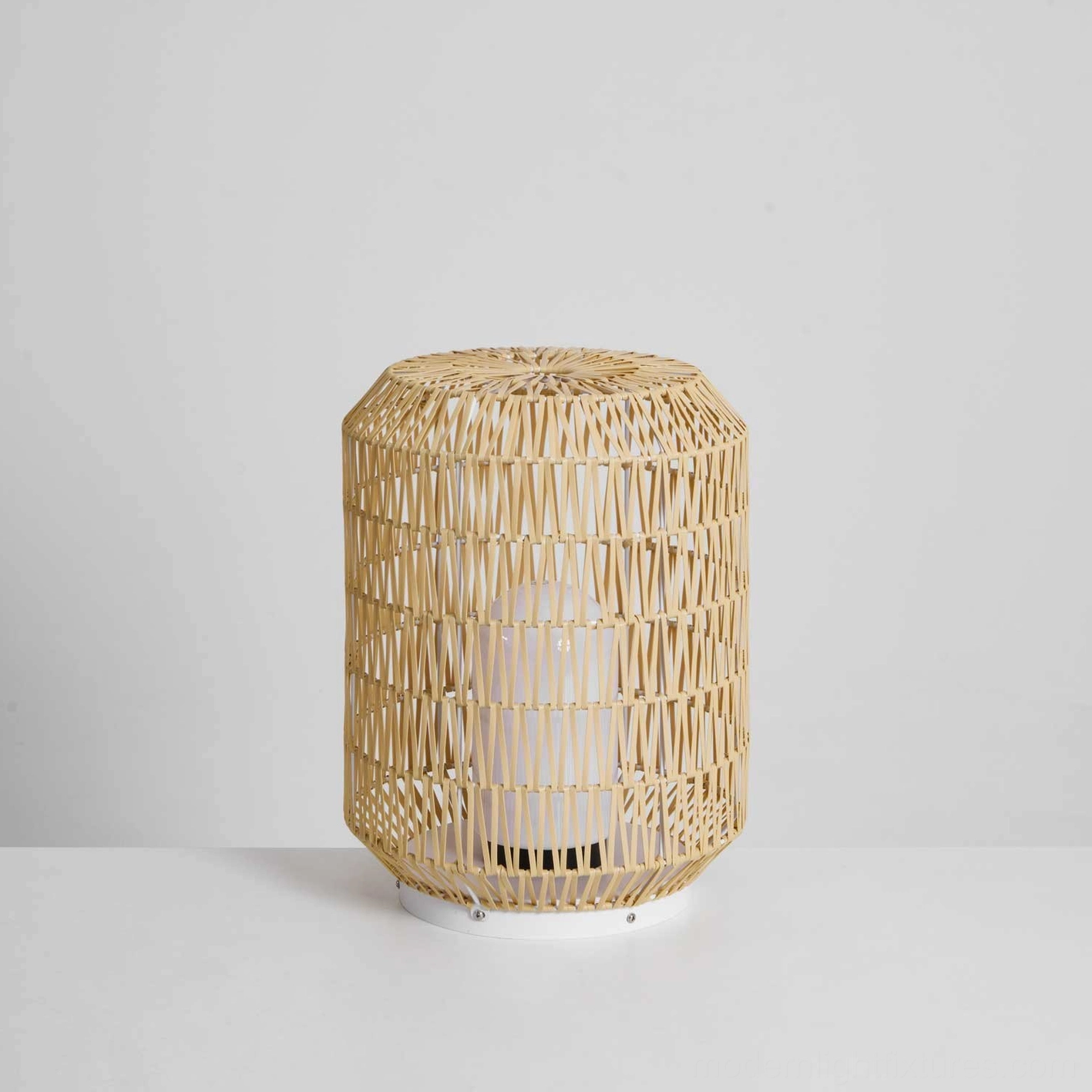 Multiple rattan outdoor lamps creating layered ambient lighting for evening outdoor dining