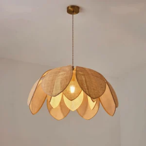Handwoven rattan lotus pendant light installed on ceiling with warm glowing bulb and brass hardware