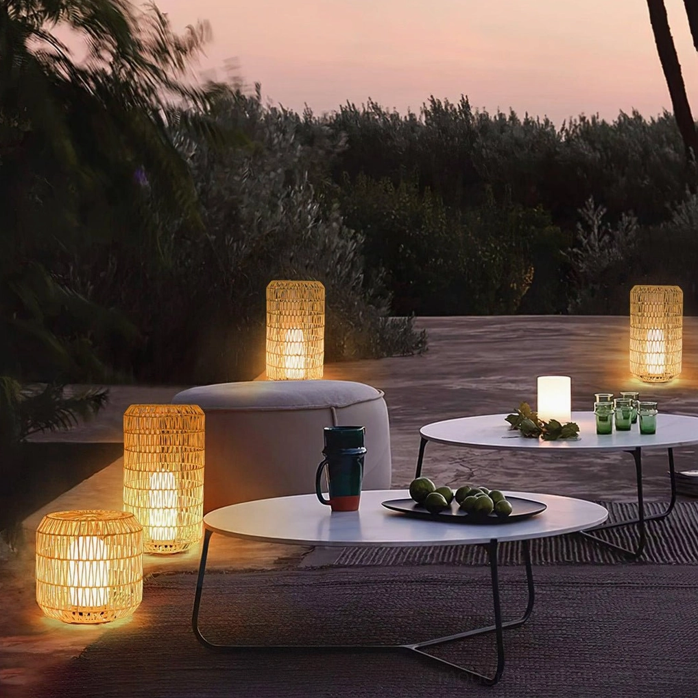 Multiple rattan outdoor garden lamps creating ambient lighting at sunset on spacious gathering patio