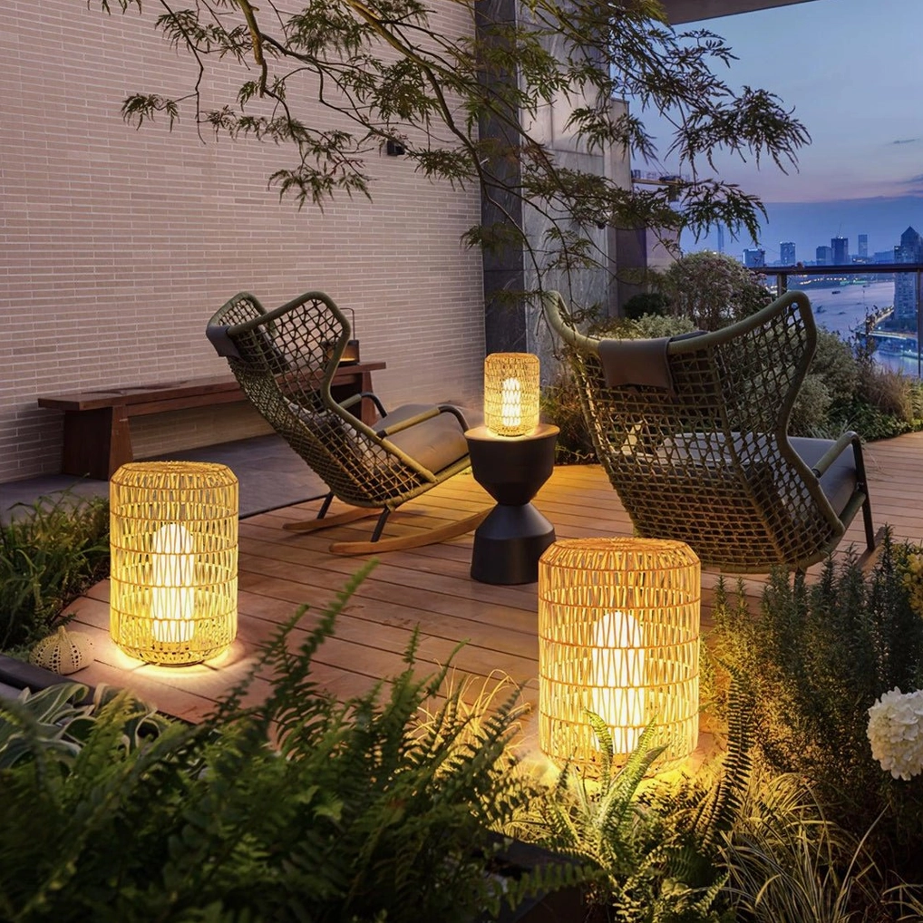 Multiple rattan outdoor patio lanterns arranged at night on waterfront lounge terrace