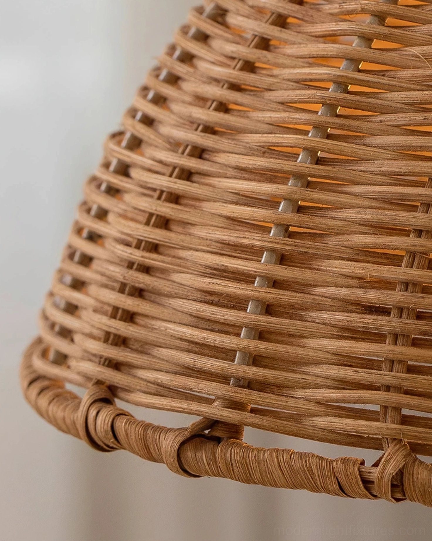 Natural rattan pendant lamp suspended with adjustable wire length in contemporary living space