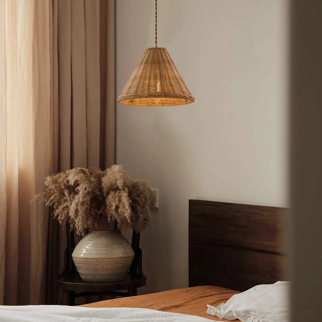 Rattan pendant lamp installed in warm bedroom interior, casting soft ambient light with dappled shadow patterns on walls