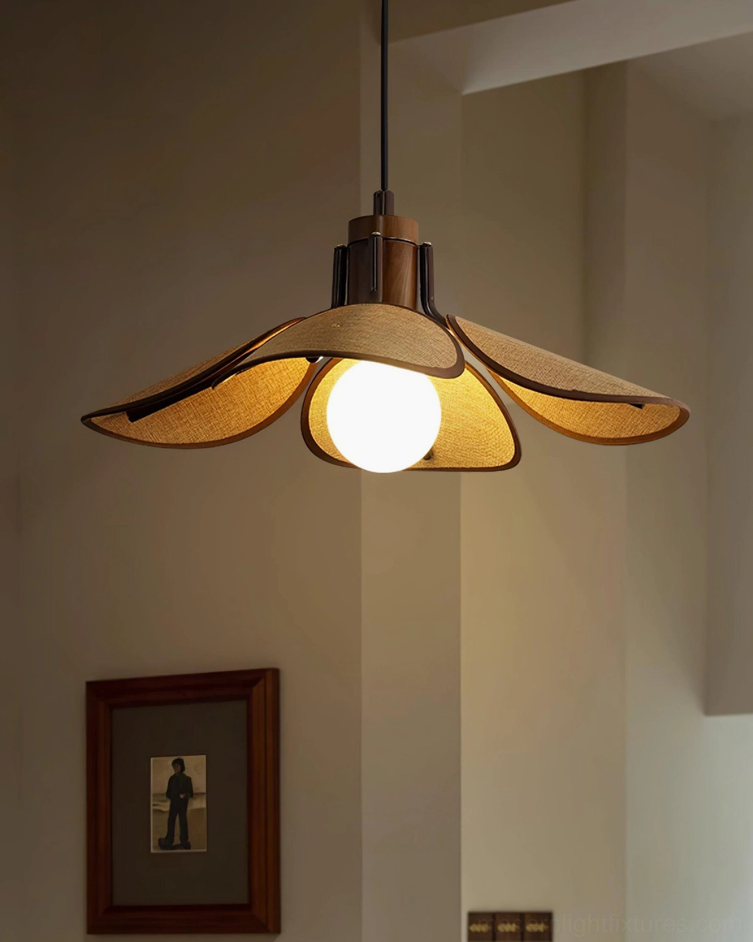 Modern rattan pendant light installation showing suspension wire and ceiling attachment hardware