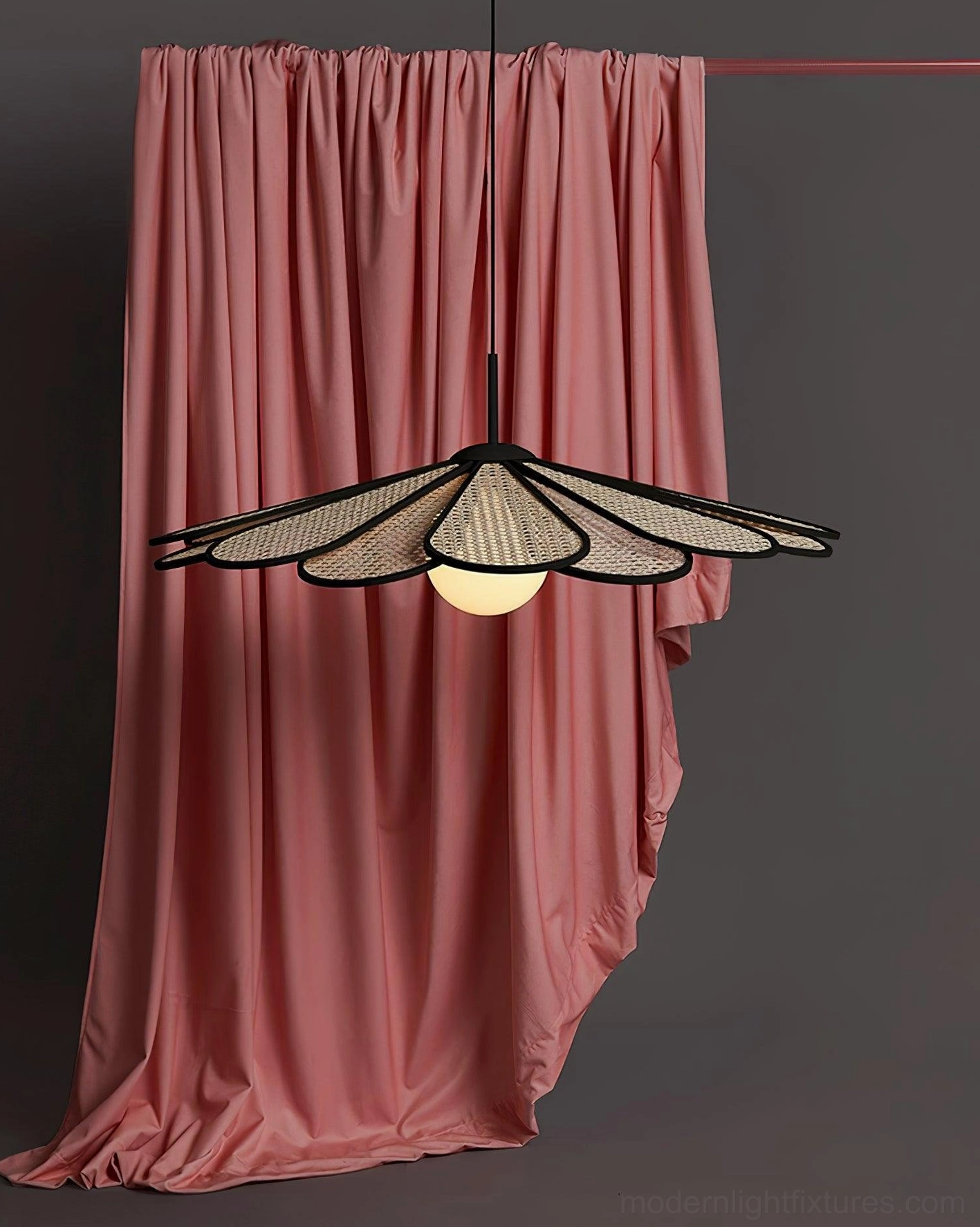 Modern rattan pendant lamp with adjustable wire length displayed in staged home interior scene