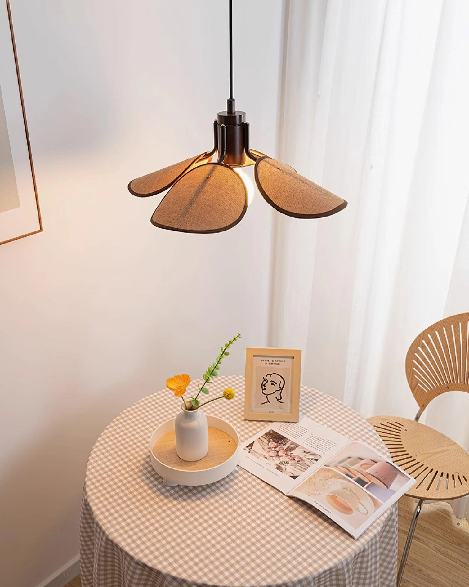 Rattan pendant lamp with dark brown suspension cord in Japandi interior design aesthetic