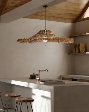 Rattan pendant lamp installed above modern kitchen island, showing natural woven texture and warm ambient lighting in contemporary kitchen