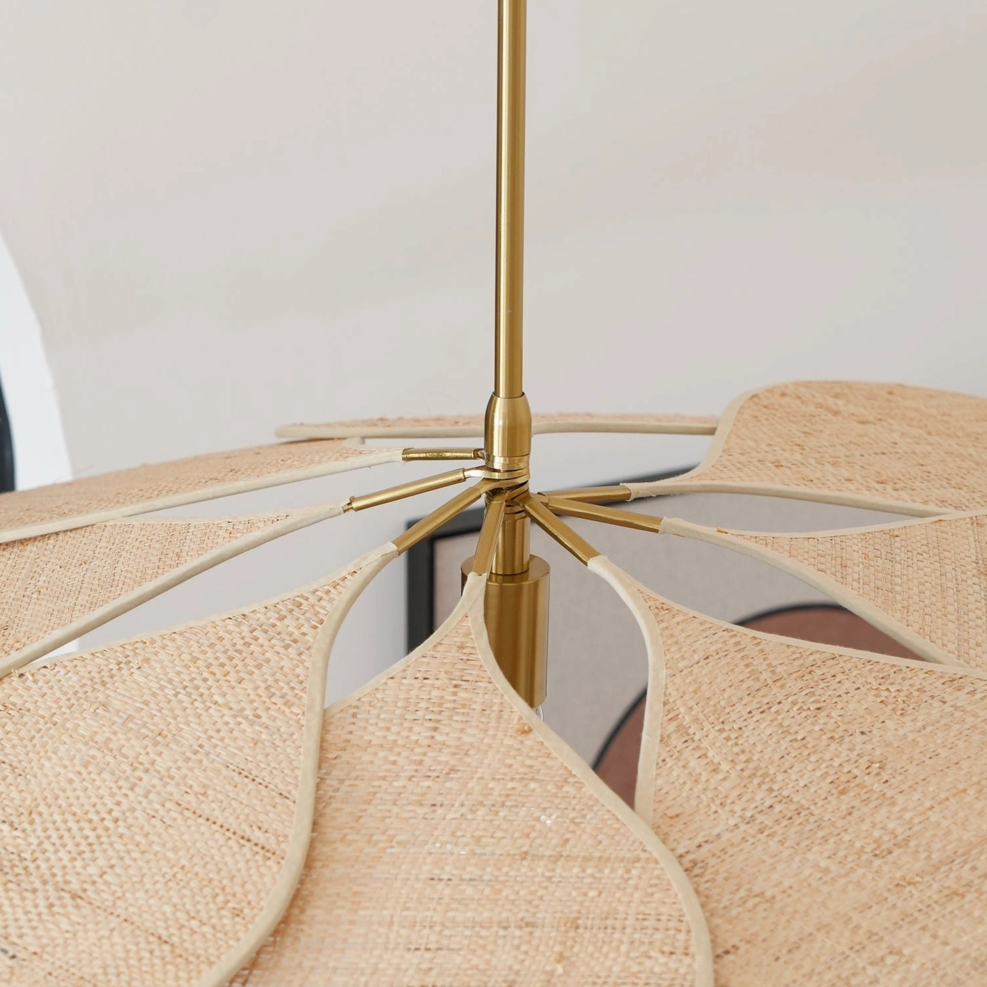 Rattan pendant lamp showing petal detail and light transmission through natural material layers