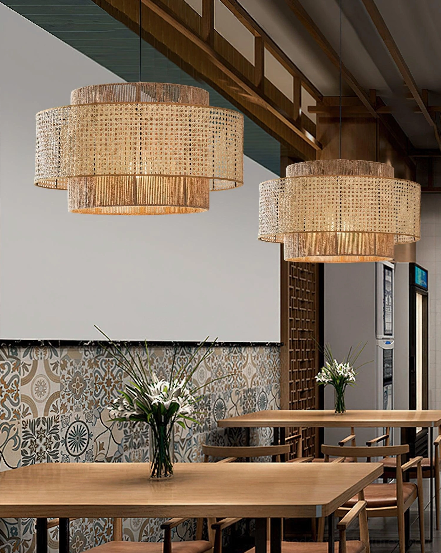 Rattan pendant lamps in commercial restaurant dining area with decorative tiled wall, professional lighting installation example