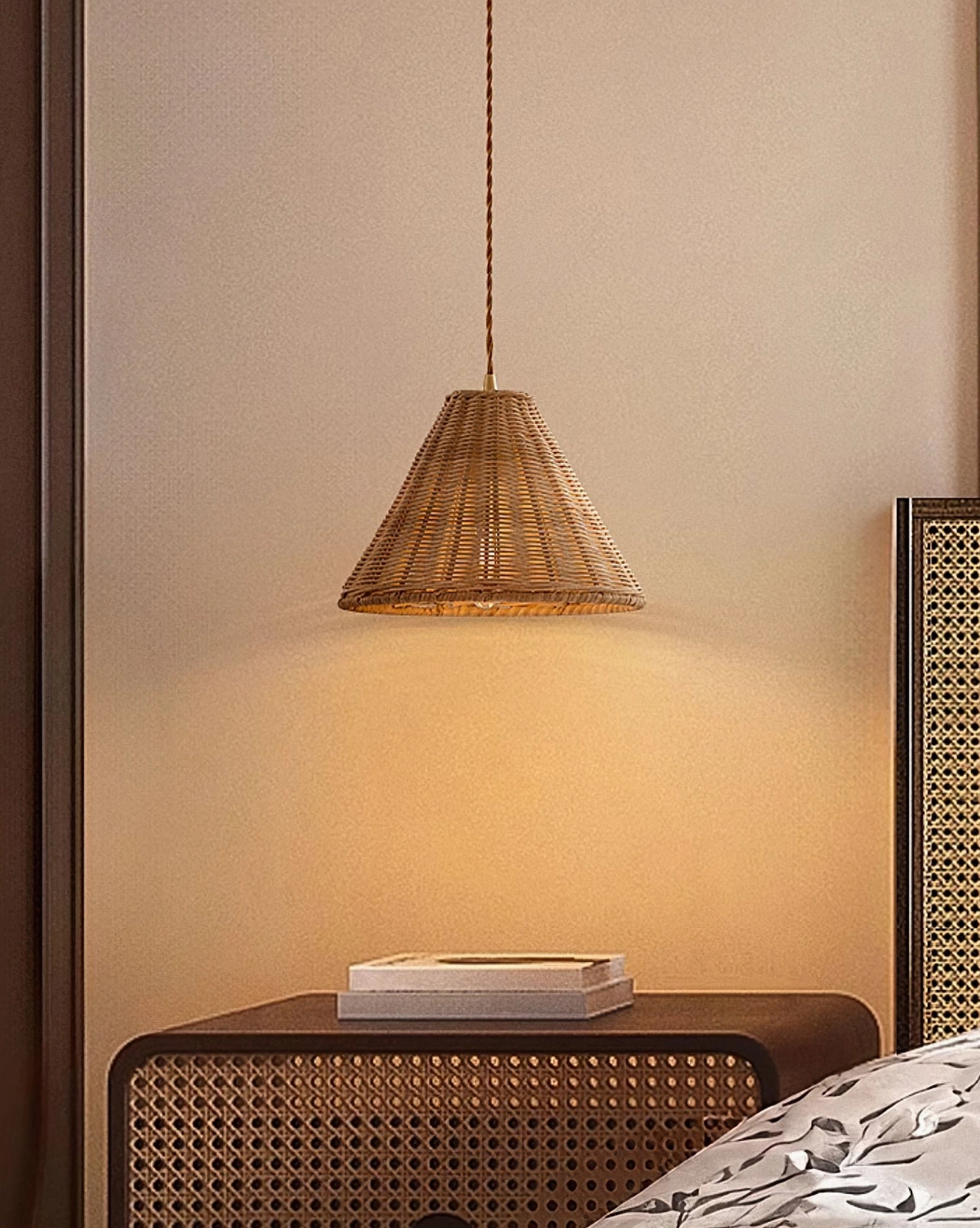 Natural rattan weave pendant light above nightstand, paired with wooden rattan furniture in boho bedroom corner
