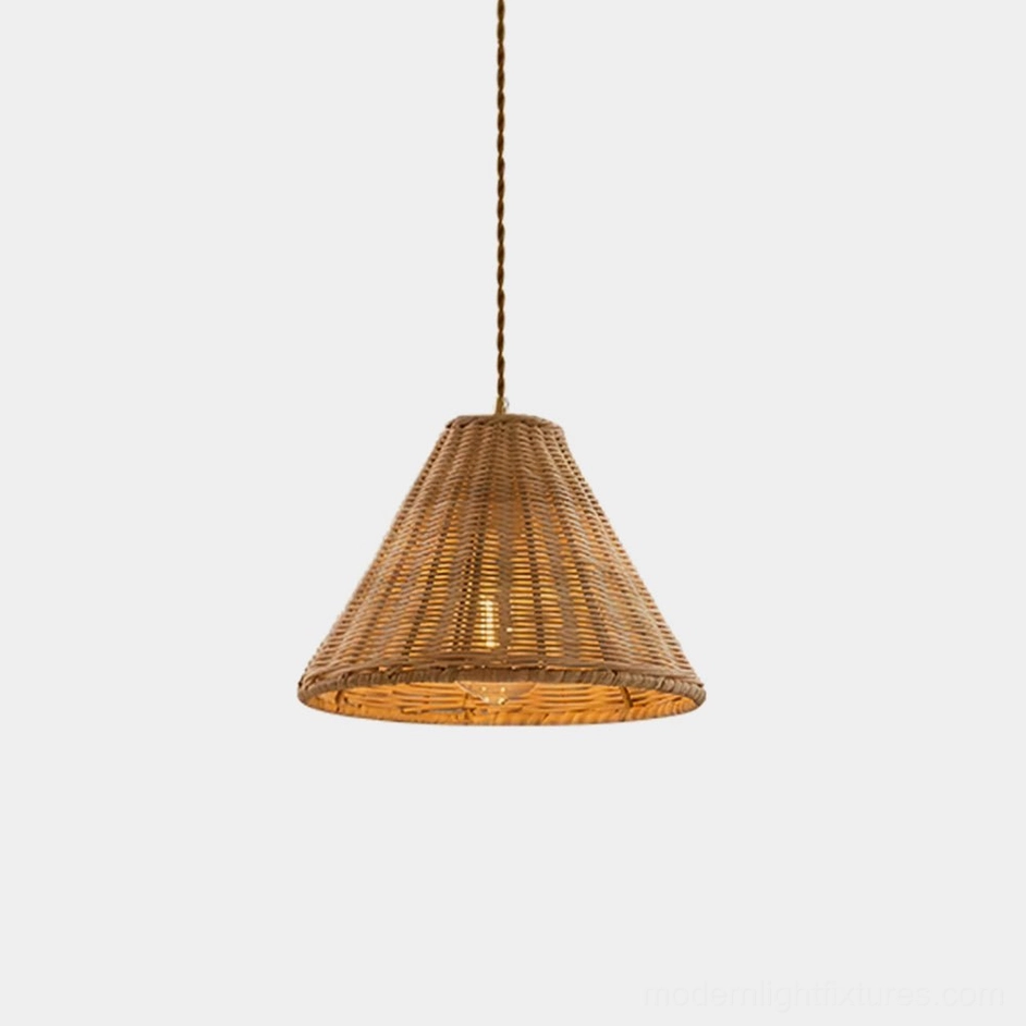 Natural rattan woven pendant light hanging in studio, conical dome shape with warm honey-brown color, boho coastal lighting fixture