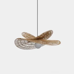 Handwoven rattan pendant light with flower-shaped natural brown wicker design and frosted white spherical glass bulb, front studio view