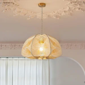 Rattan pendant light installed in luxury French-style living room with ornate ceiling trim and brass hardware